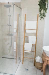 a bathroom with a shower and a toilet and a sink at Explore the City from Its Center in a Chic Balcony Apartment in Bucharest +12 photos