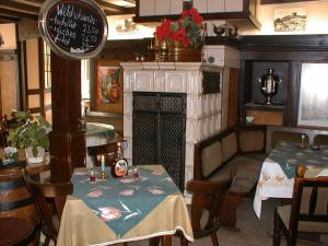a dining room with two tables and a fireplace at Hotel Alt Wassenberg in Wassenberg