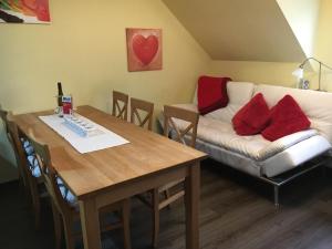 a living room with a table and a couch at Ferienwohnung Helga in Bendorf
