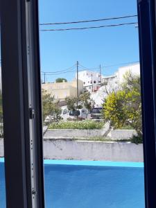 a window with a view of a parking lot at Villa Firostefani in Firostefani