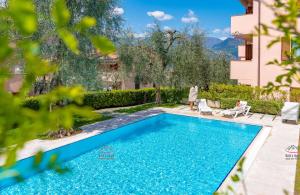 a swimming pool in the backyard of a house at Garden Beth's House in Brenzone sul Garda