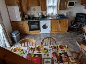 a kitchen with a table with a table cloth on it at The Rathbarn in Newry
