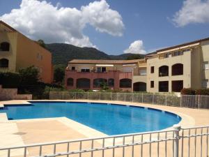 a large swimming pool in front of some buildings at Le Noisetier in Cavalaire-sur-Mer