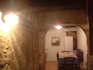 a dining room with a table and a stone wall at Ca' Morano in Pavullo nel Frignano