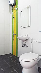 a bathroom with a toilet and a sink at Mitra Hotel in Yogyakarta