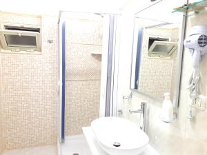 a bathroom with a shower with a toilet and a sink at Residence Maresol in Vieste