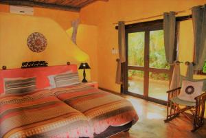 a bedroom with a bed and a sliding glass door at Kwalucia Private Safari Retreat in St Lucia