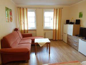 a living room with a couch and a table at Landhaus Goeres in Briedel