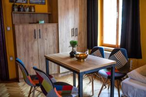 a living room with a wooden table and chairs at Dežnik in Ljubljana