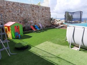 a backyard with a swimming pool and a playground at Nof Lavon in Lavon