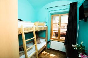 a room with two bunk beds and a window at Dežnik in Ljubljana