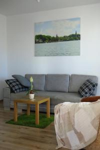 a living room with a couch and a coffee table at Apartamenty 3 kolory in Ostróda