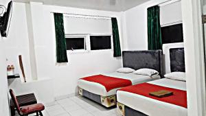 Posteľ alebo postele v izbe v ubytovaní Mitra Hotel