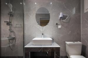 a bathroom with a sink and a shower and a toilet at De plata apartments in Sarti +76 photos