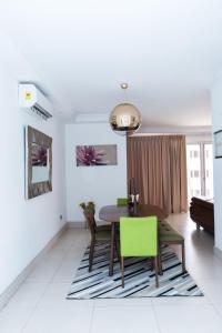 a dining room with a table and a green chair at 90 Independence Avenue in Accra