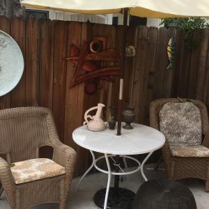 a patio with a table and chairs and a fence at Sunshine L.A in Van Nuys