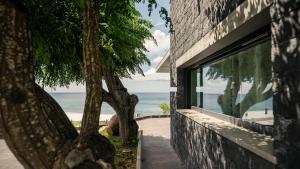 a building with a window with a view of the ocean at Villa Natura in Vila do Porto
