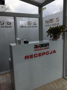 a white booth with signs on the side of it at Noclegi AVATAR Radom in Radom