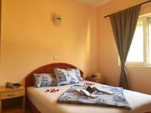 a bedroom with a bed with two towels on it at Apartments Simic in Kamenari