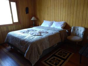 a bedroom with a bed with a robe on it at Casa da Montanha in Urubici