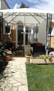 a patio with a couch under a pergola at Villa Dolce Vita in Vodice