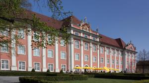 ein großes Gebäude mit Leuten, die draußen sitzen in der Unterkunft Ferienwohnung Braun in Meersburg