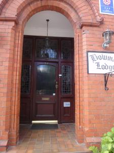 an entrance to a brick building with a wooden door at Bowman Lodge in Chester +33 photos