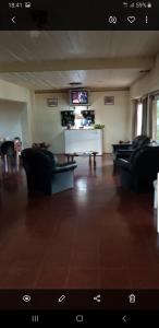 a living room with two couches and a tv at Hotel POSTA NORTE in Posadas