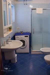 a bathroom with a washing machine and a washer at Il Canto di Partenope in Naples