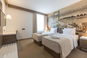 Postel nebo postele na pokoji v ubytování Hotel Royal Inn