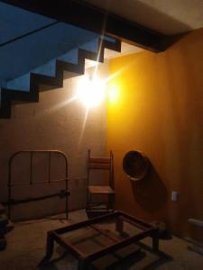 a room with a table and a chair and a light at Loft Calicanto con Cochera in Guanajuato +2 photos
