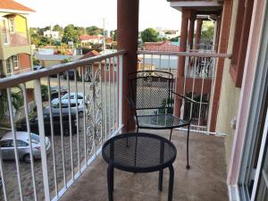 two chairs and a table on a balcony at 12 Fairway Avenue in Kingston