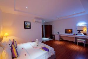 a hotel room with a bed and a desk at Starry Angkor Hotel in Siem Reap