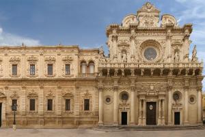 a large stone building with a clock on it at filobrocante in Torre Santa Susanna