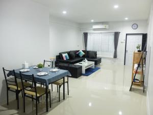 a living room with a table and a couch at HDY 16 Home in Hat Yai