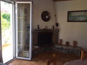 a living room with a fireplace and a glass door at Europe Studios in Zóla