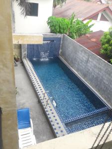 an overhead view of a swimming pool with a blue tiled at B Happy Resort - SHA ExtraPlus in Kamala Beach