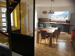 a kitchen and dining room with a table and chairs at Les Terrasses du Donon in Raon-lès-Leau