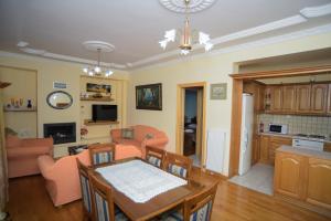 a kitchen and living room with a table and chairs at Villa Irini Ammousa in Ágios Nikólaos