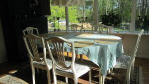 a dining room table with four chairs around it at Villa Pernilla in Orkelljunga