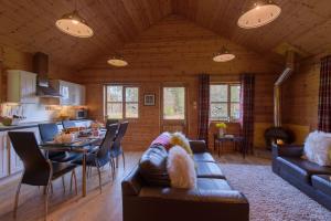 a living room with a couch and a dining room at Ben Macdui in Banchory