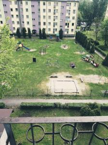 Blick auf einen Park mit Spielplatz in einem Gebäude in der Unterkunft Perfekt place in Oświęcim