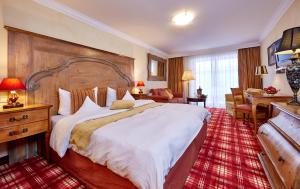 a bedroom with a large bed in a hotel room at Romantik Alpenhotel Waxenstein in Grainau +49 photos