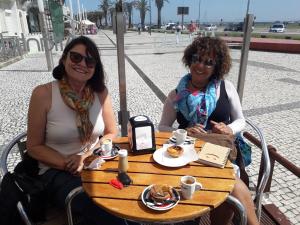 two women sitting at a table with coffee and food at Aveiro Central - It´s ALL there in Aveiro