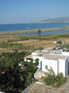 a white building with a view of the ocean at Askella in Agios Prokopios