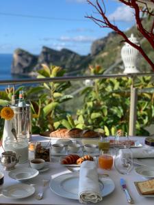 a table with food on it with a view of the ocean at Quattro Passi Relais in Nerano