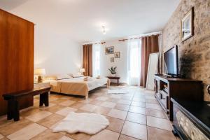 a living room with a bed and a tv at Heart of Town in Zadar