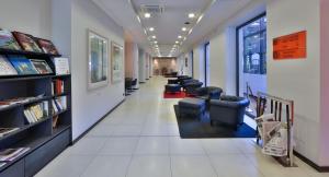 a long hallway with chairs and a waiting room at Best Western Falck Village Milano Sesto in Sesto San Giovanni