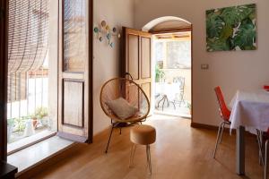 a dining room with a table and chairs and windows at 44 Steps - Enjoy Noto in Noto