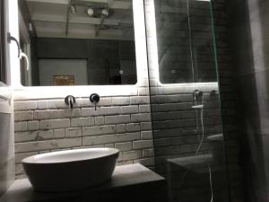 a bathroom with a sink and a mirror at Athens Airport, Seaside house in Artemida +15 photos